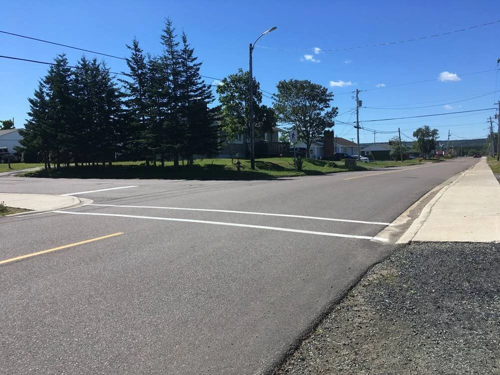 Reynolds Street after Replacement with new asphalt, curb, sidewalk and safe crosswalk for children to access bus stop.