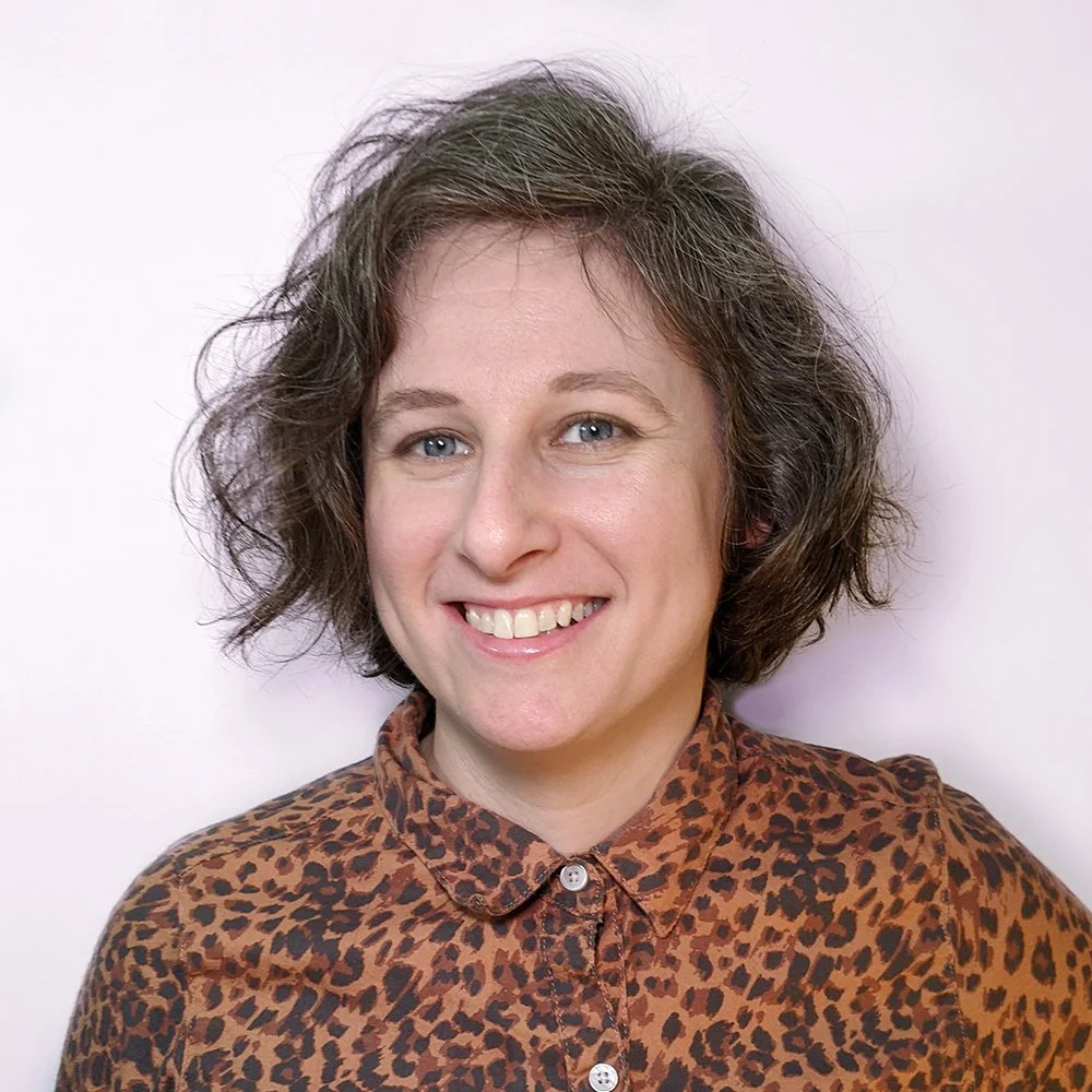 Smiling caucasian woman with blue eye and dark brown and grey hair