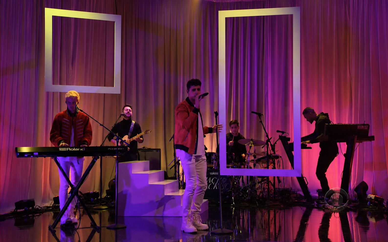 Jack & Jack performing on stage on the Late Late Show with James Corden with colorful lighting and large decorative frames.
