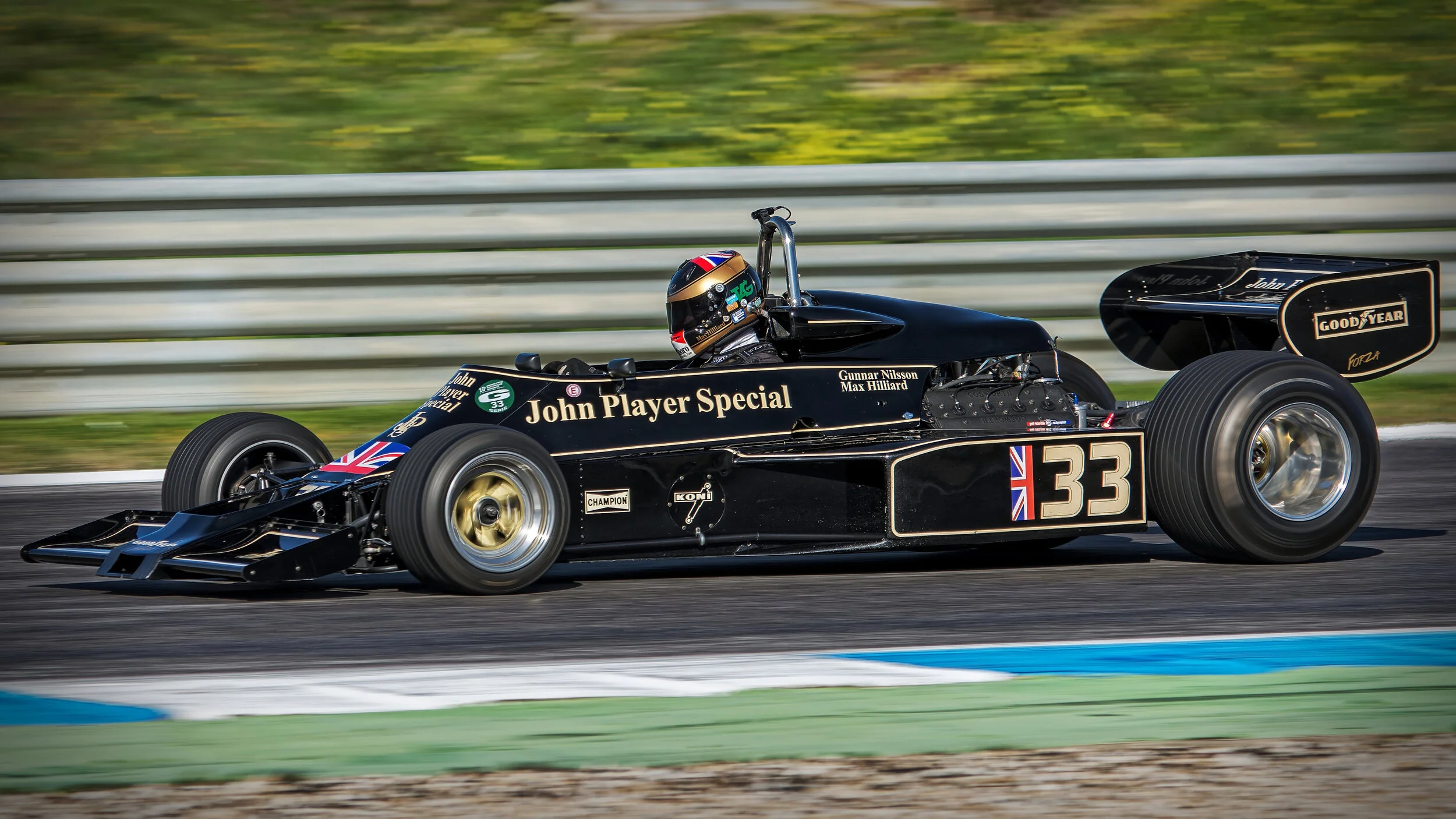 Vintage Formula One race car with "John Player Special" livery on track.