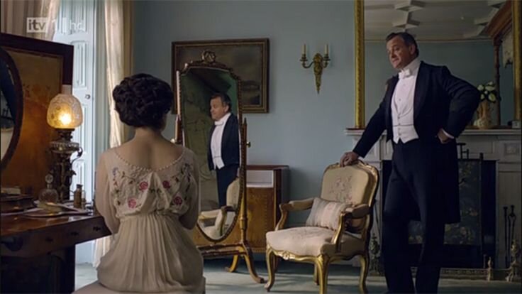 In this poor quality photograph you can just see the beautiful color of the pale blue walls which look so good with the gilded gold of the mirror, chairs and wall sconces.
