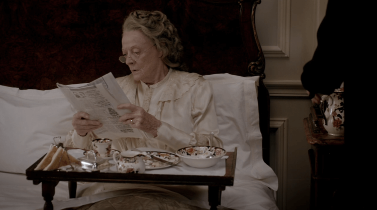The Dowager observing the news whilst having break’g the news whilst having breakfast in bed.