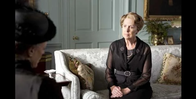 I just love that color on the walls! Also the silk settee and needlepoint cushions.