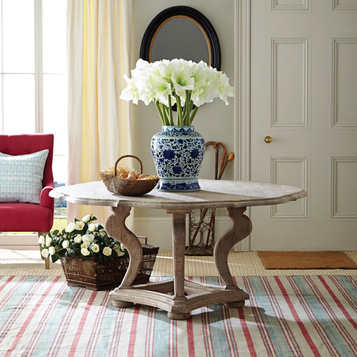 A round table with a large flower-filled vase is always a smart lookCLICK HERE TO SHOP
