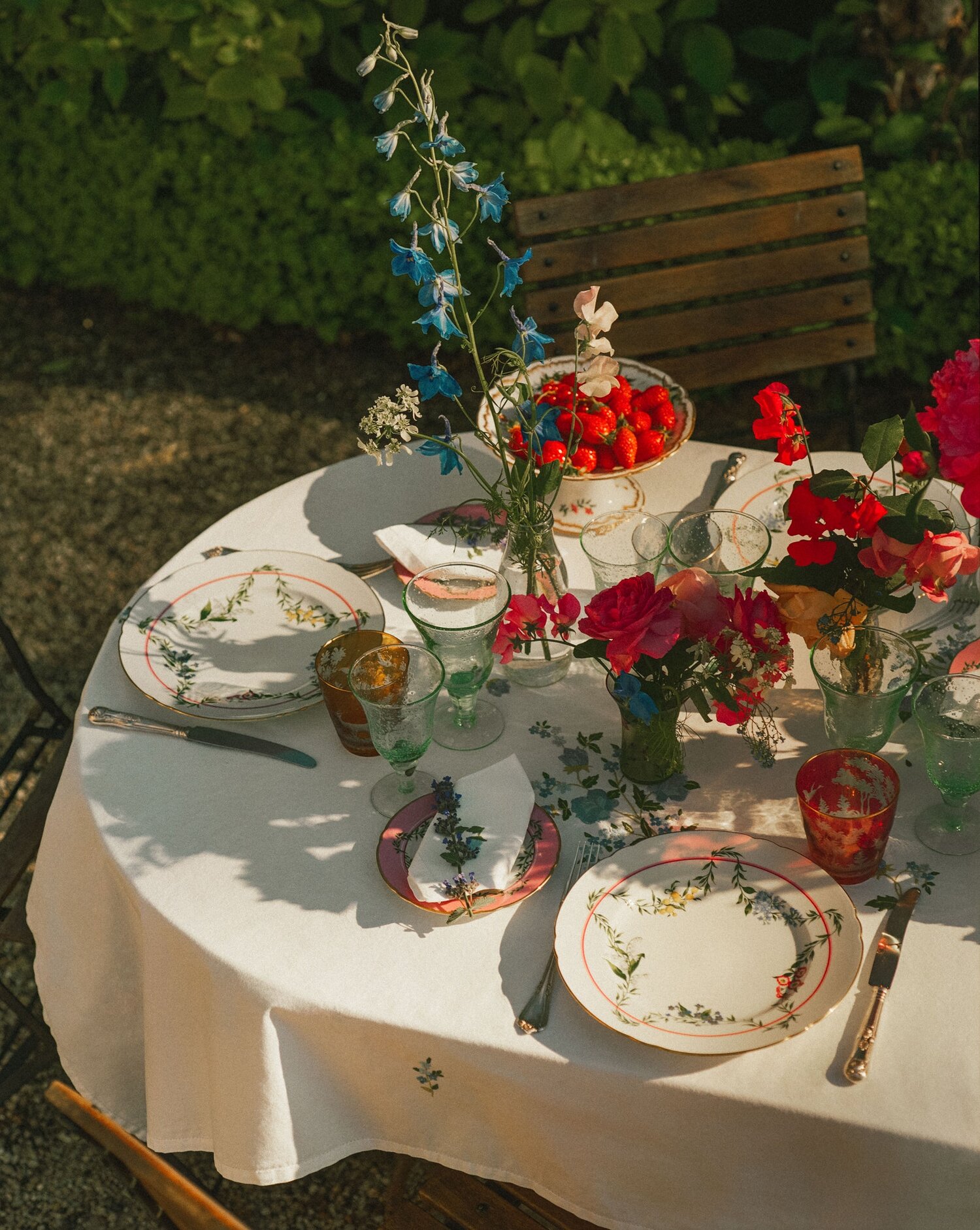 The table is set with fine linens, flowers, and china