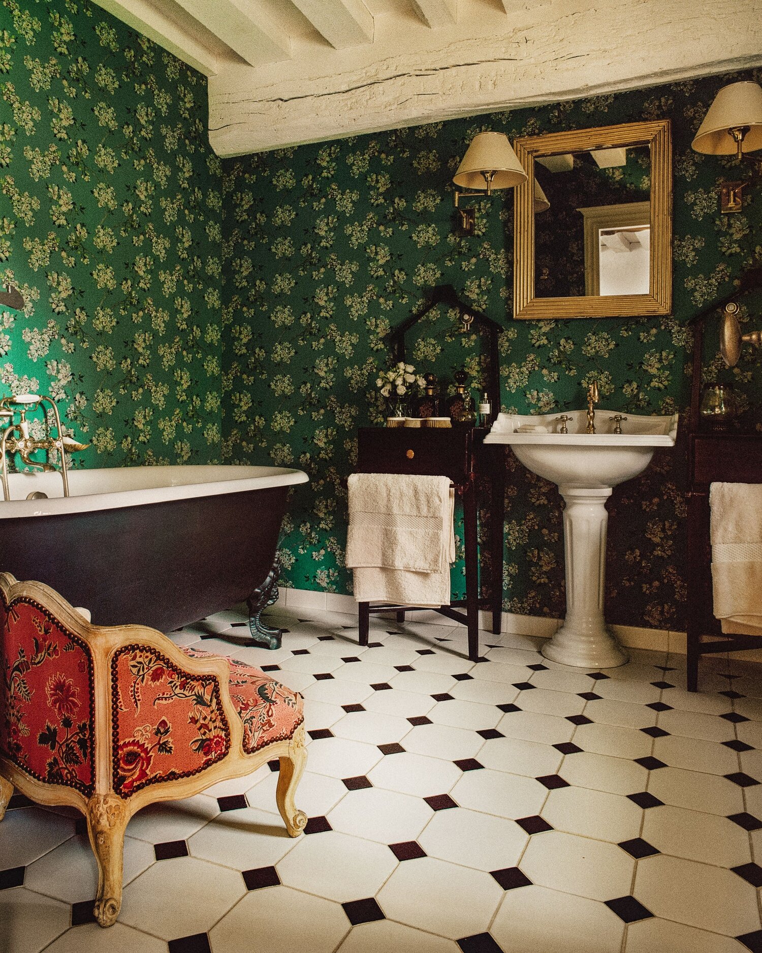 I just adore this bathroom with the green wall covering and mix of antiques. I always say that a bathroom should feel inviting and not clinical.