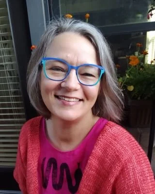 Lisa Headings, expressive arts therapist, sitting on a balcony