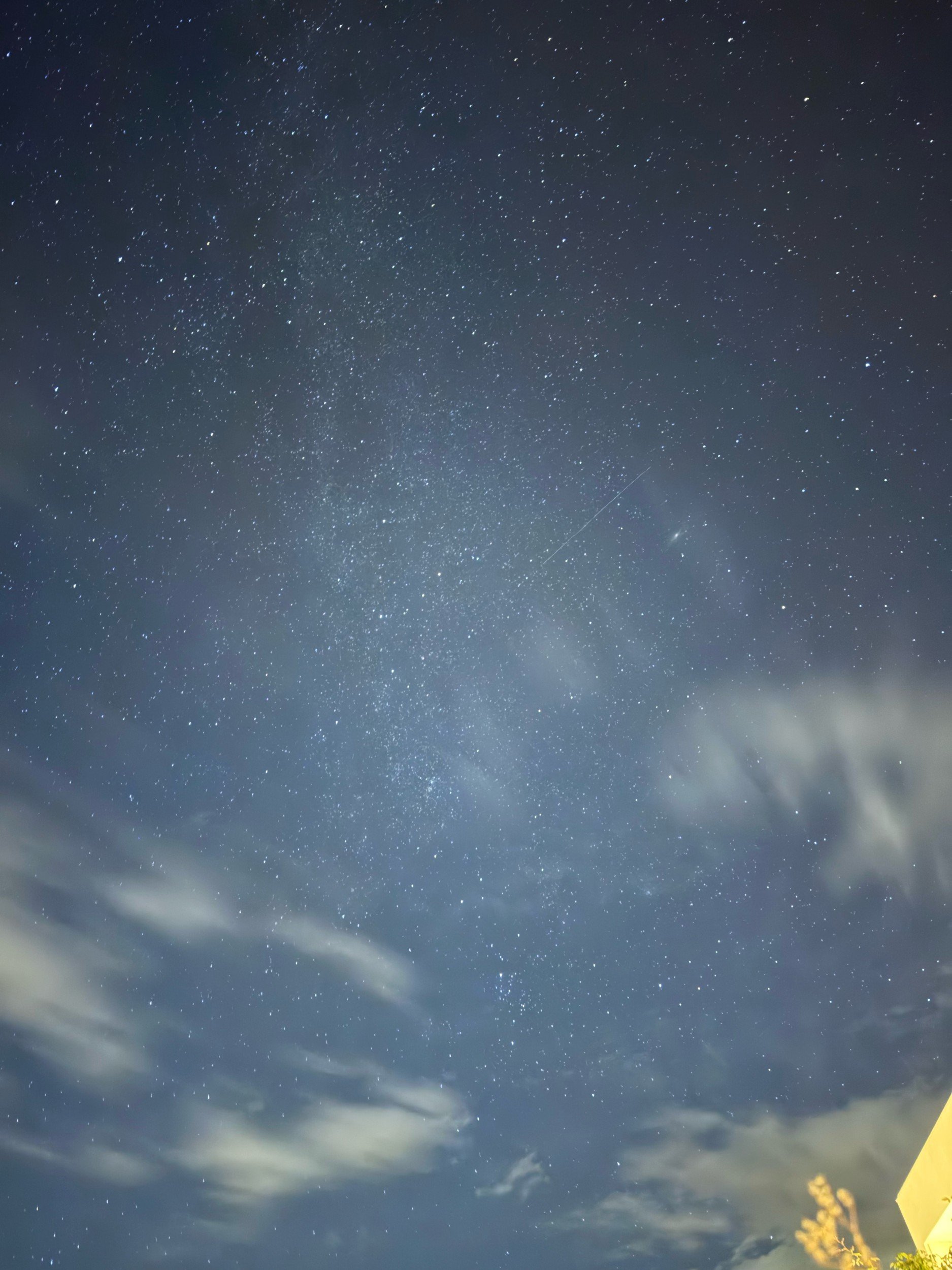 A starry night sky over the Douro Valley with passing clouds.