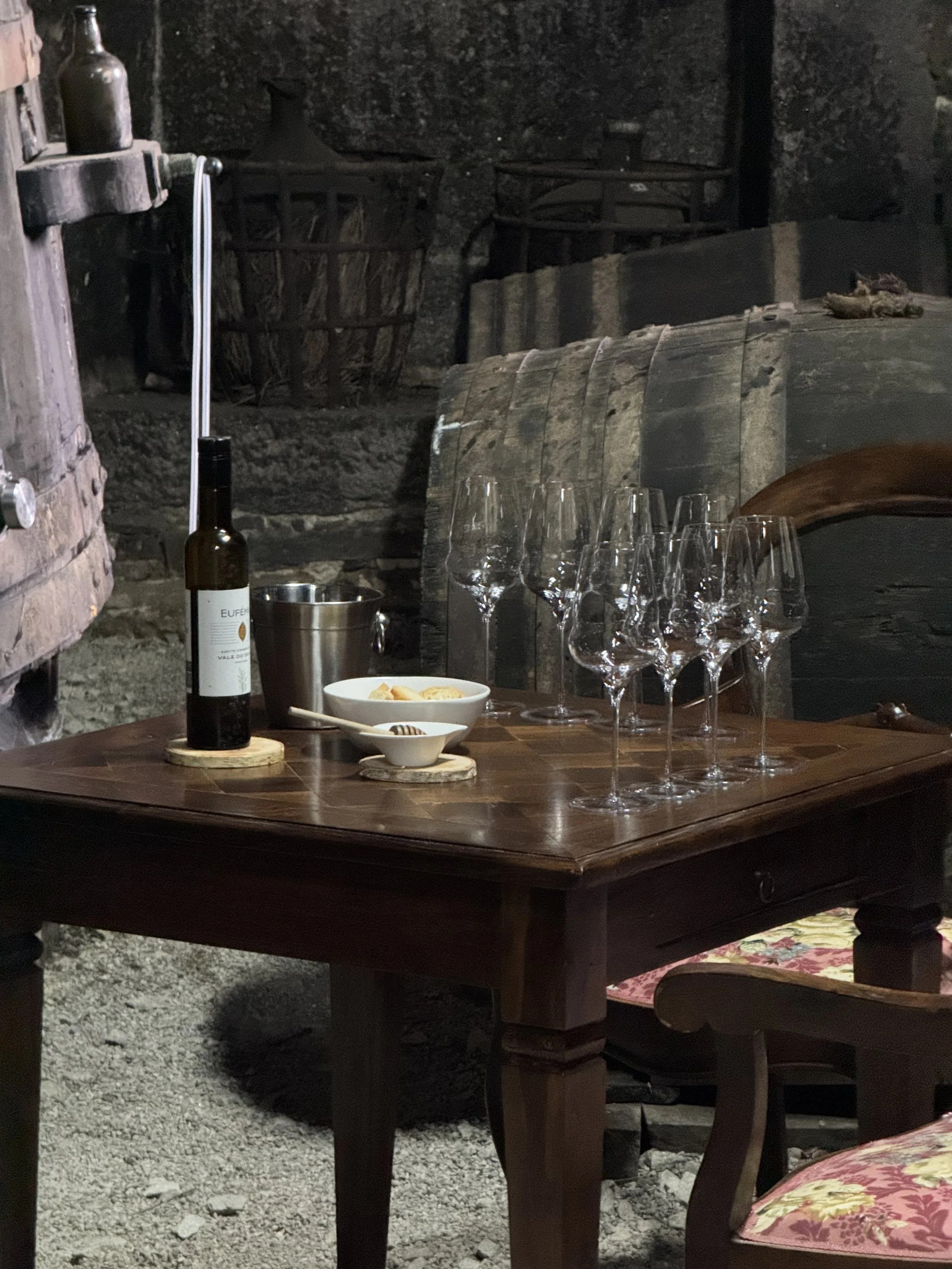 A tasting table set with glasses in the cellar at Casa de Santa Eufémia.