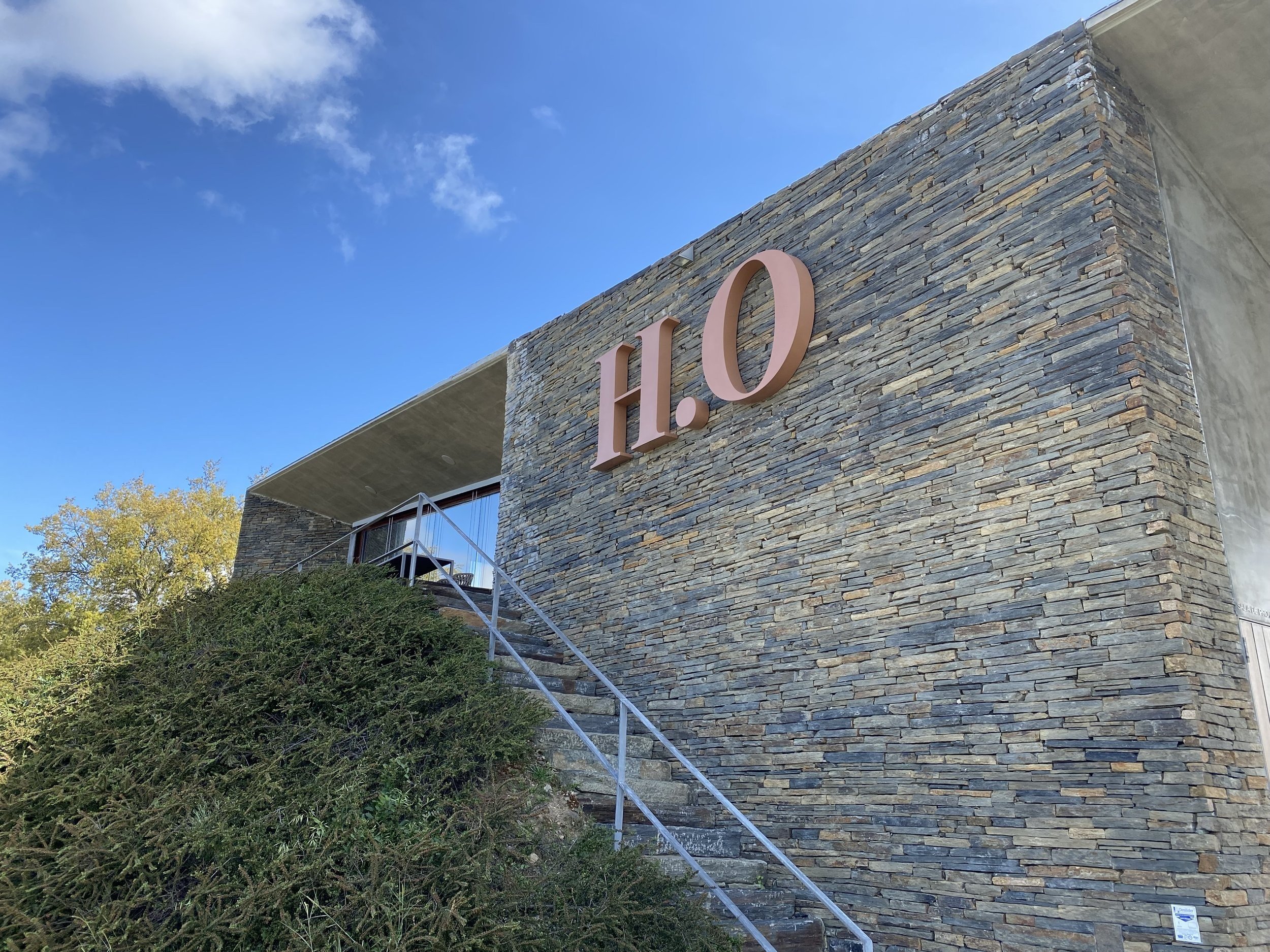 The H.O. sign on the schist wall of the H.O. Winery in Cumieira.