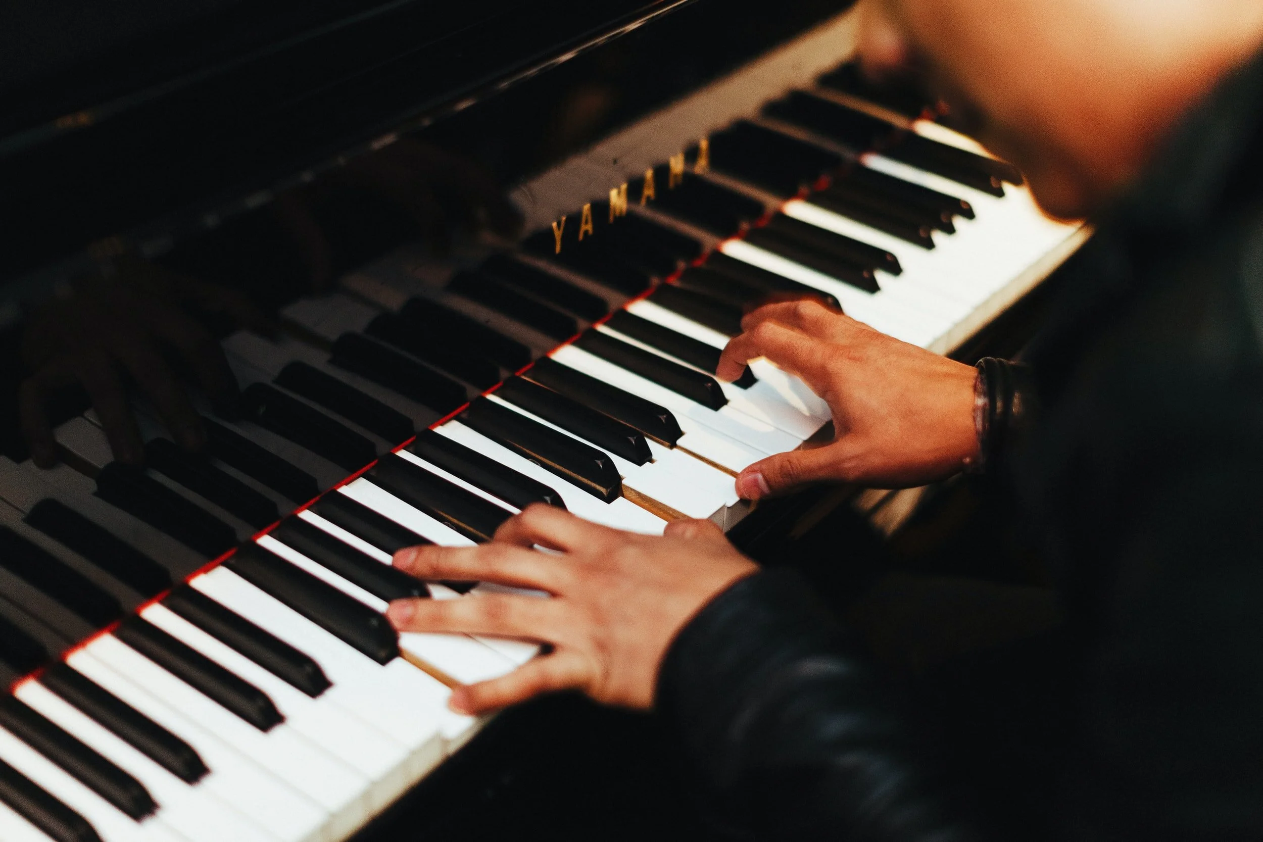 Piano student playing chords during a private lesson
