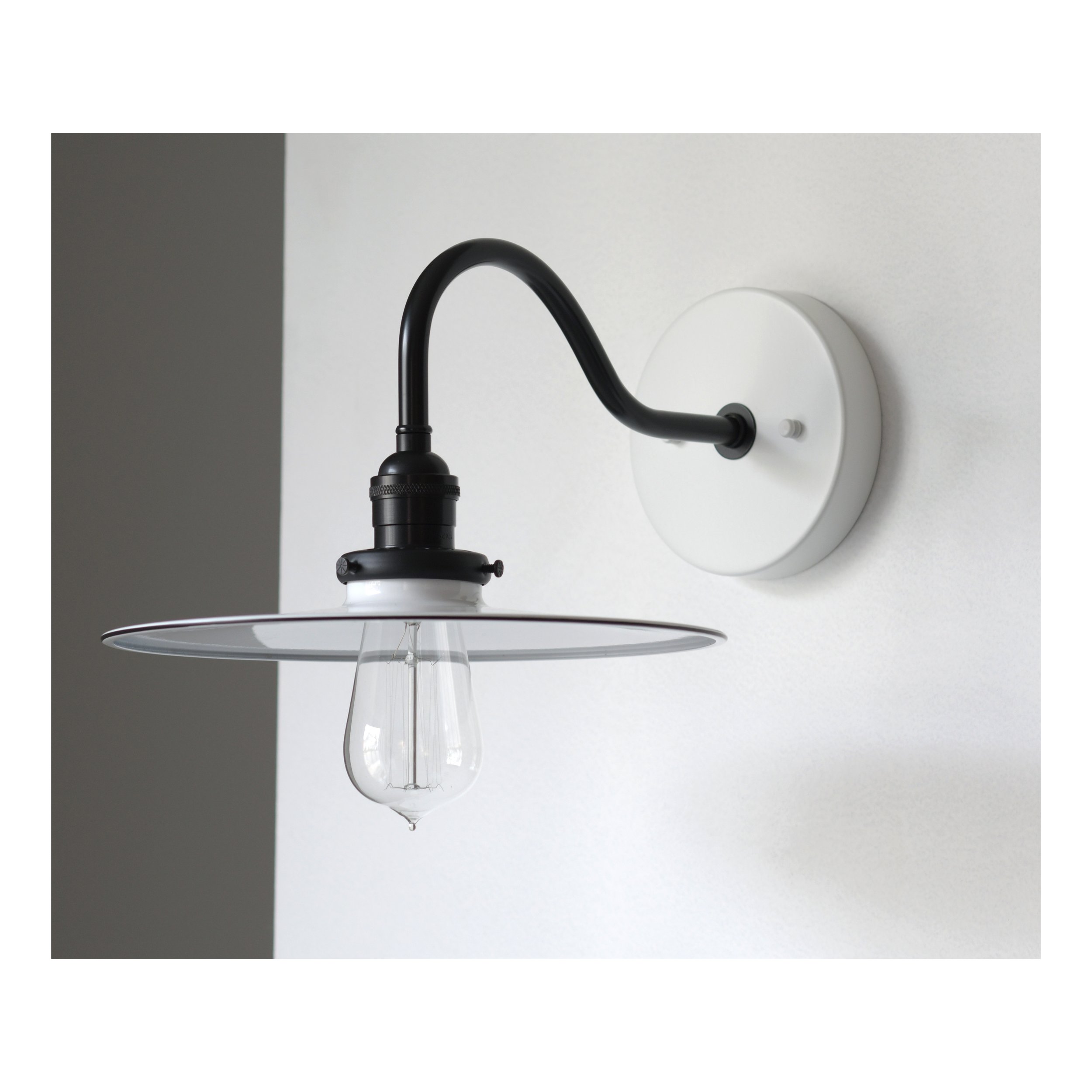 Black - Curved arm sconce.