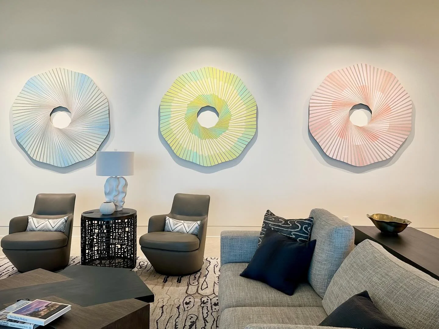 Artist Jay Shinn creates minimal geometric abstract works that explore light, form, and optical and physical presence. Cosmic Memo 1, Cosmic Memo 2, and Cosmic Memo 3 are separate acrylic on birch panel paintings that come together beautifully in one
