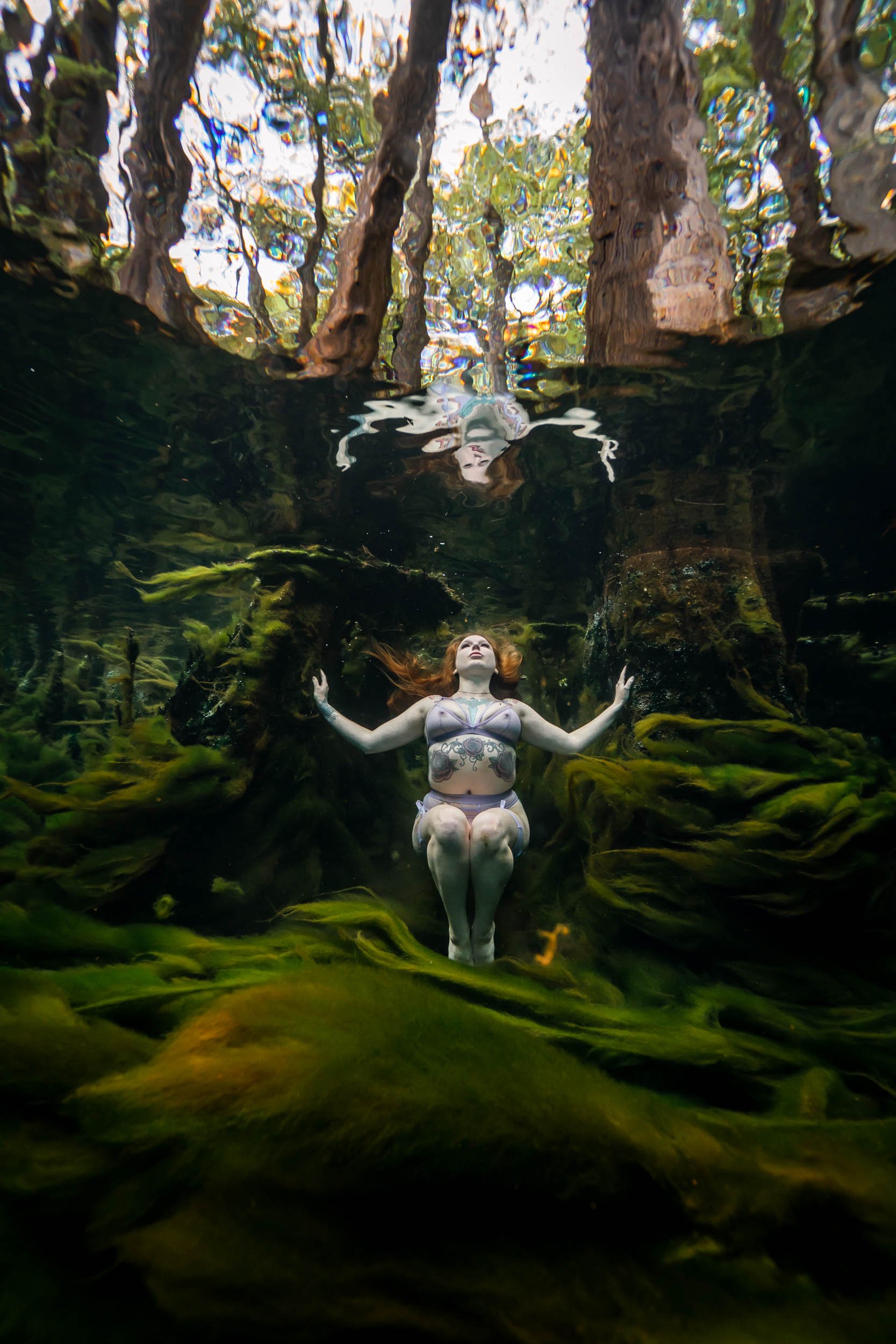 Underwater model Aimee posing in the seagrass