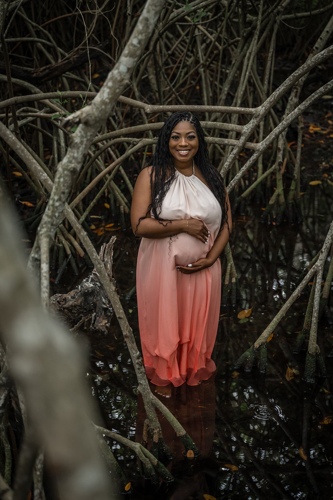 A pregnant African American woman posing for a Jungle photoshoot in Tulum