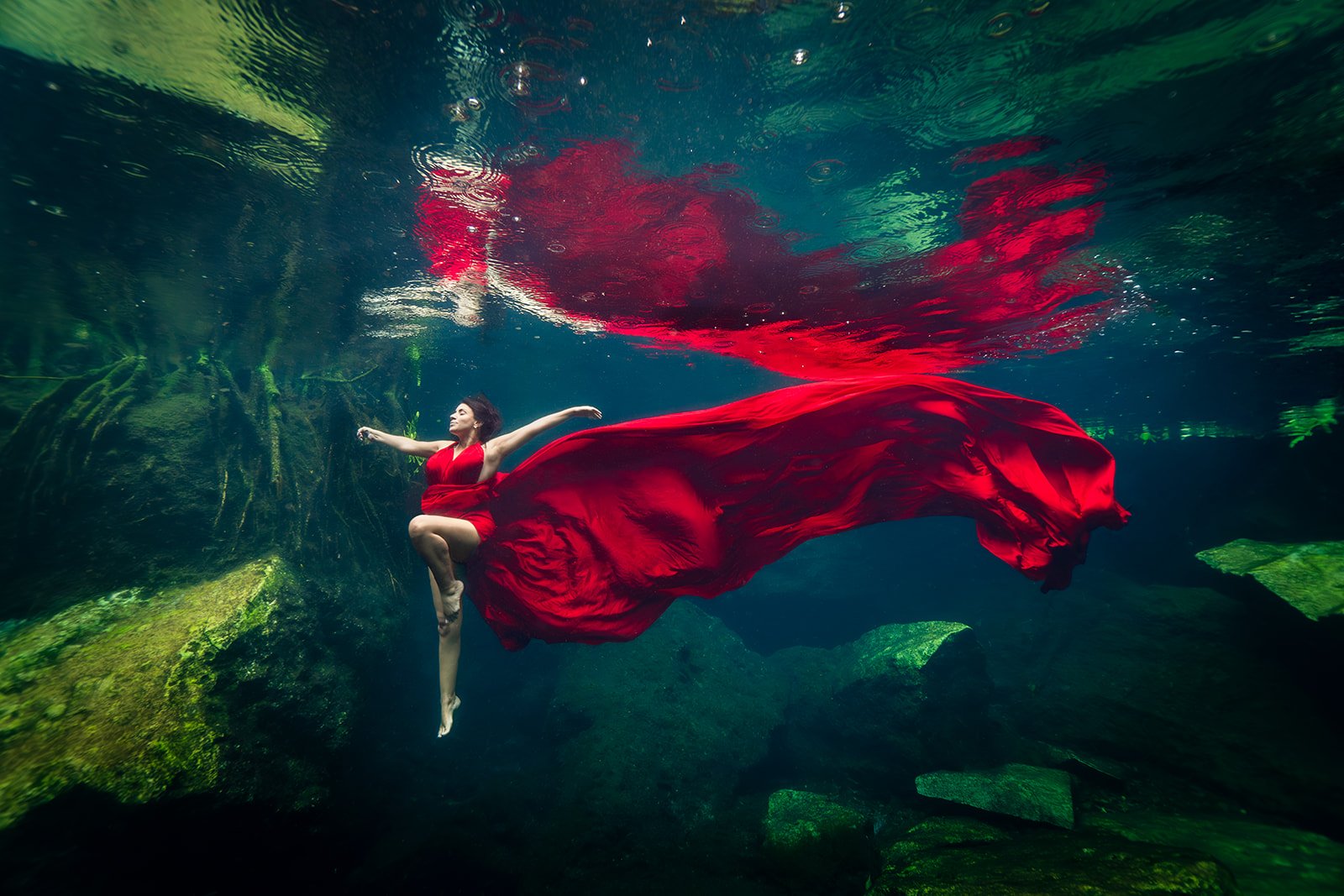 A woman posing for an underwater photoshoot in a rainy day