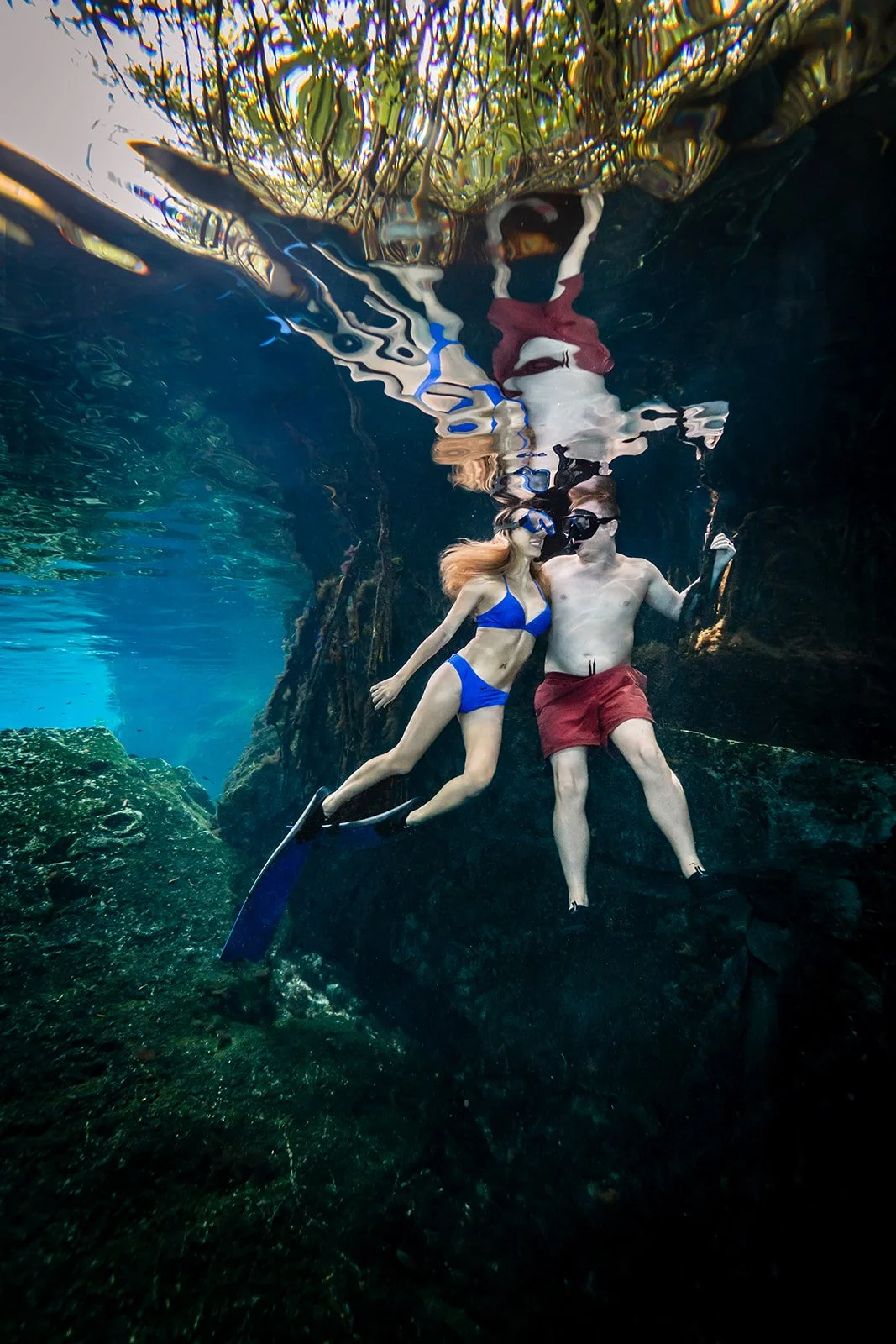 A couple posing for an underwater portrait in a mexican cenote