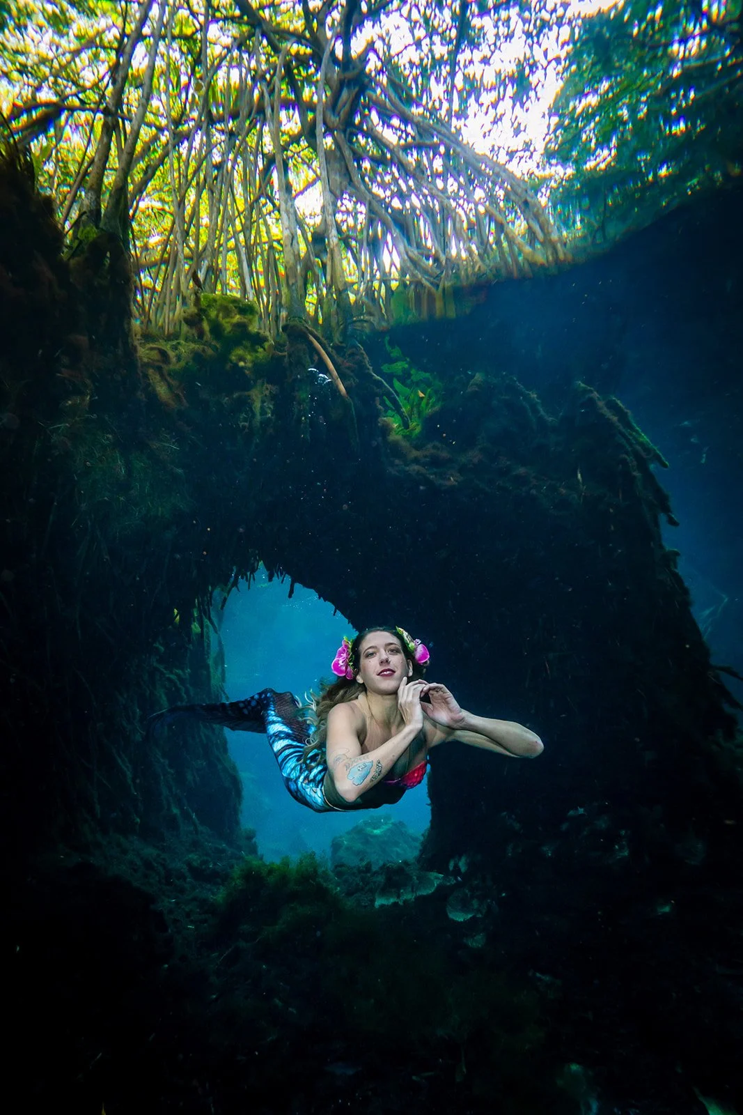 Mermaid Model showcasing waterproof makeup during an underwater cenote photoshoot