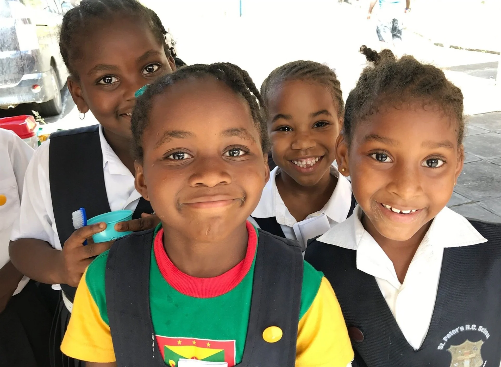 Grenadian children smiling after receiving dental care from Spice Isle Smiles volunteers