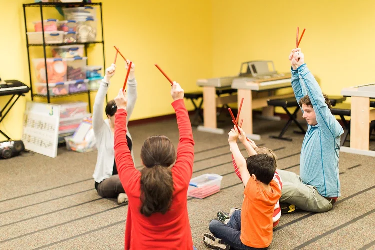 Children exploring rhythm and drumming during a music class