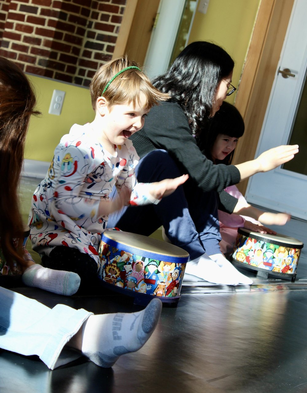 Children and adults participating in a Rhythm Kids class at Olenka School of Music