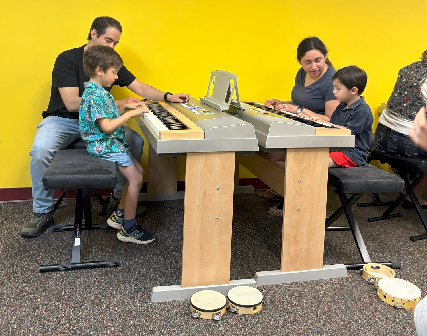 Young students participating in a keyboard class at Olenka School of Music