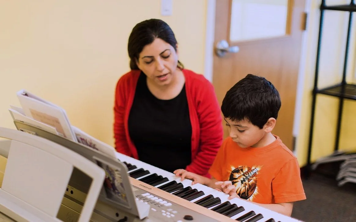 Young students learning music together at Olenka School of Music