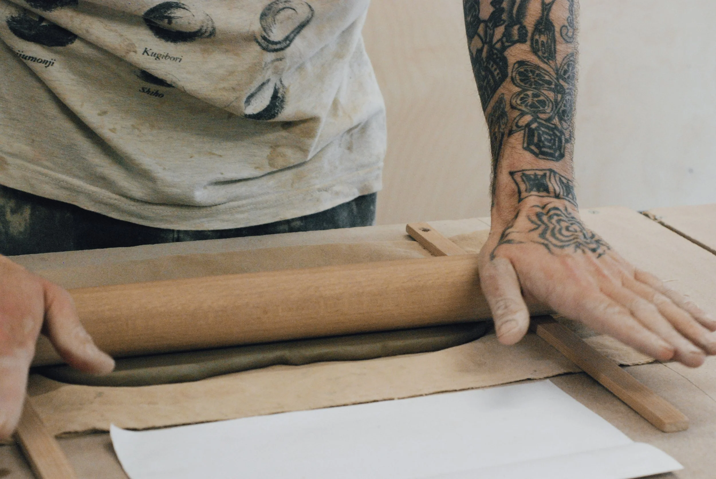 a person rolling out a clay slab