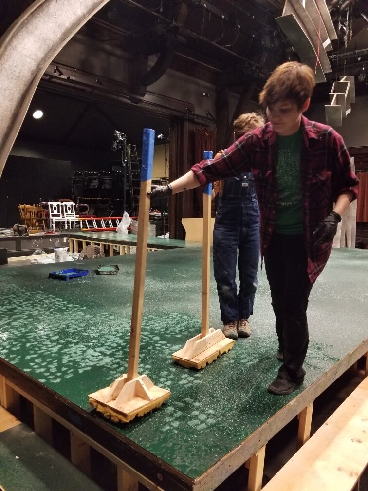 Featuring myself and another student. This is the floor for Spring Awakening (2017) using large handmade stamping tools to create a semi-regular texture. The two stamps shown are made from mattress foam and are slightly different from one another.