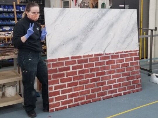 Marble and brick texture on canvas.
Bricks were achieved by two different methods. One method focused on painting the brick texture as a base and adding the grout later, and the other method was the exact opposite.