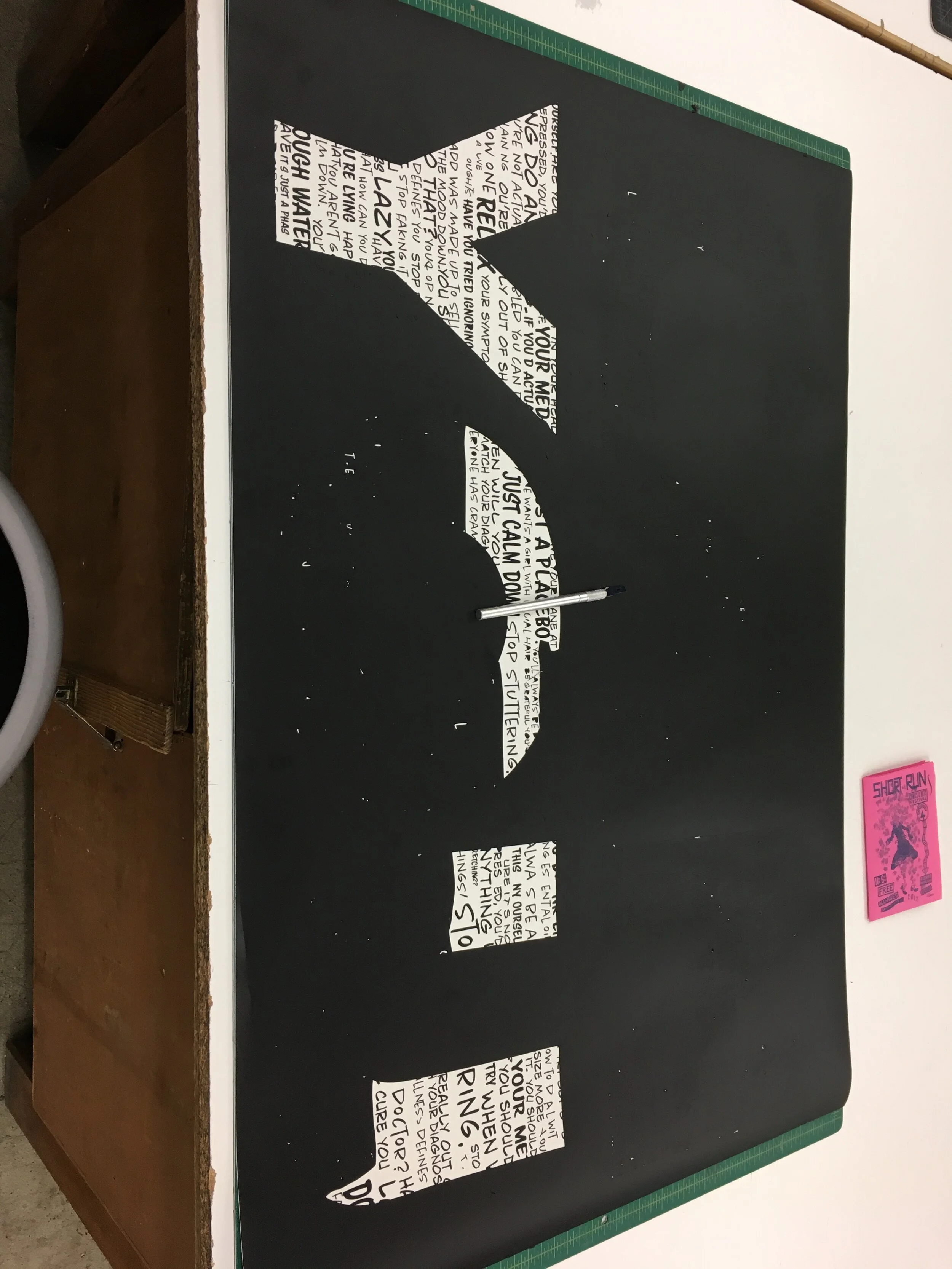 A process photo of the prepping of the vinyl. This process is called "weeding" and is when the excess vinyl is removed from around the cuts. 