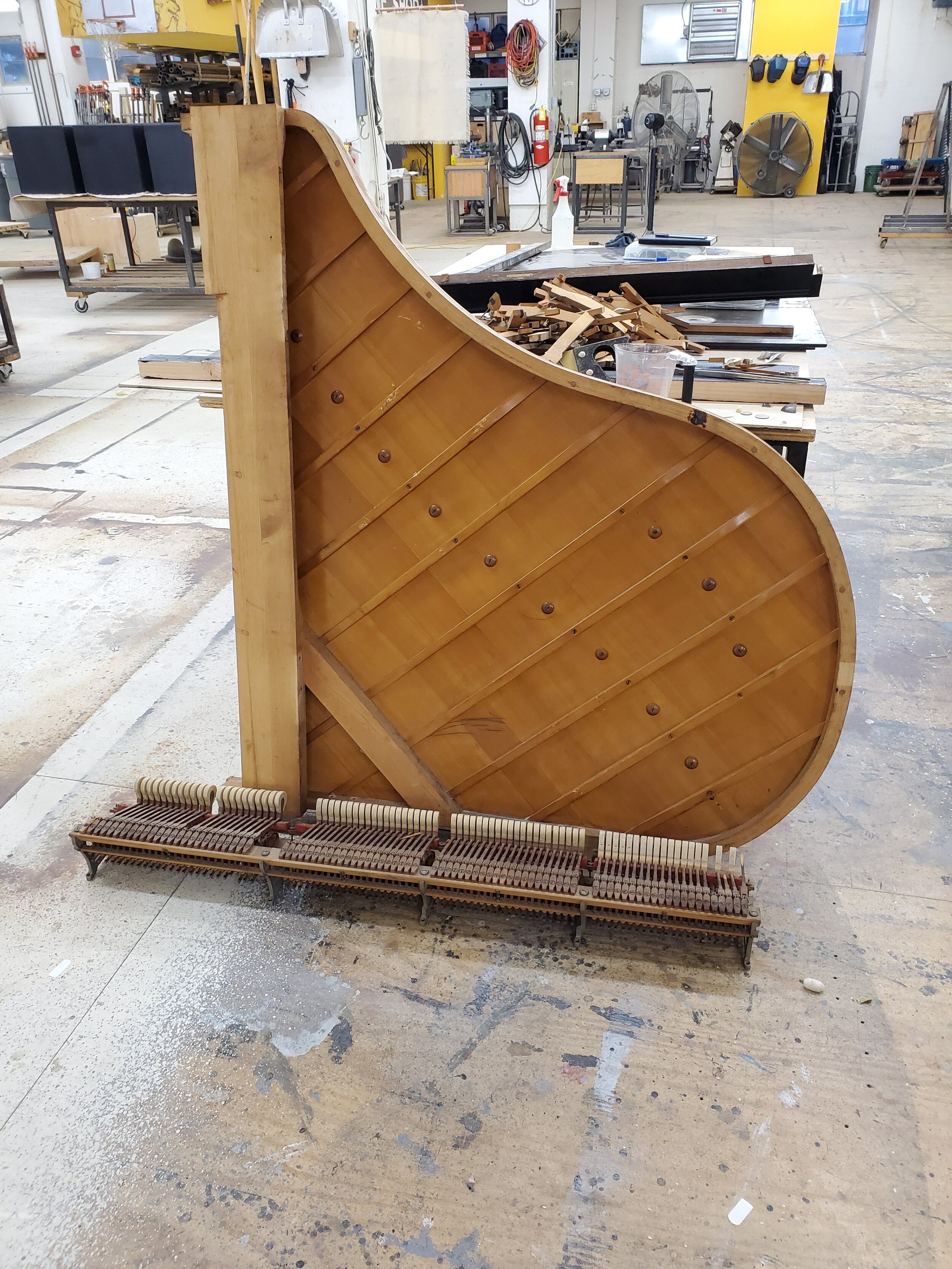 The sounding board and the hammer mechanism, removed from the piano.