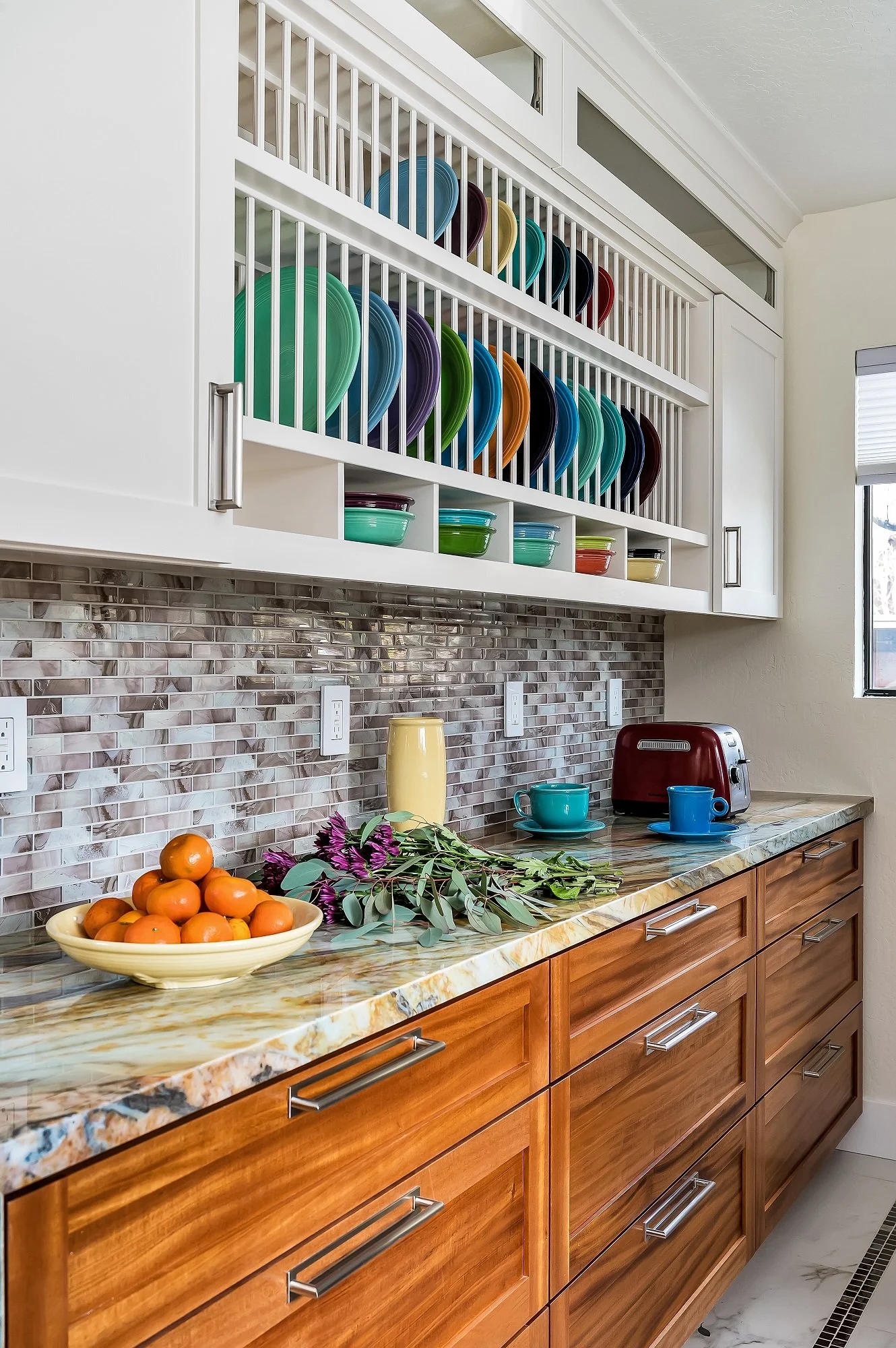 Custom kitchen storage detail in this Santa Cruz condo remodel, featuring wood base cabinetry, open plate display, and a textured tile backsplash designed for everyday use.