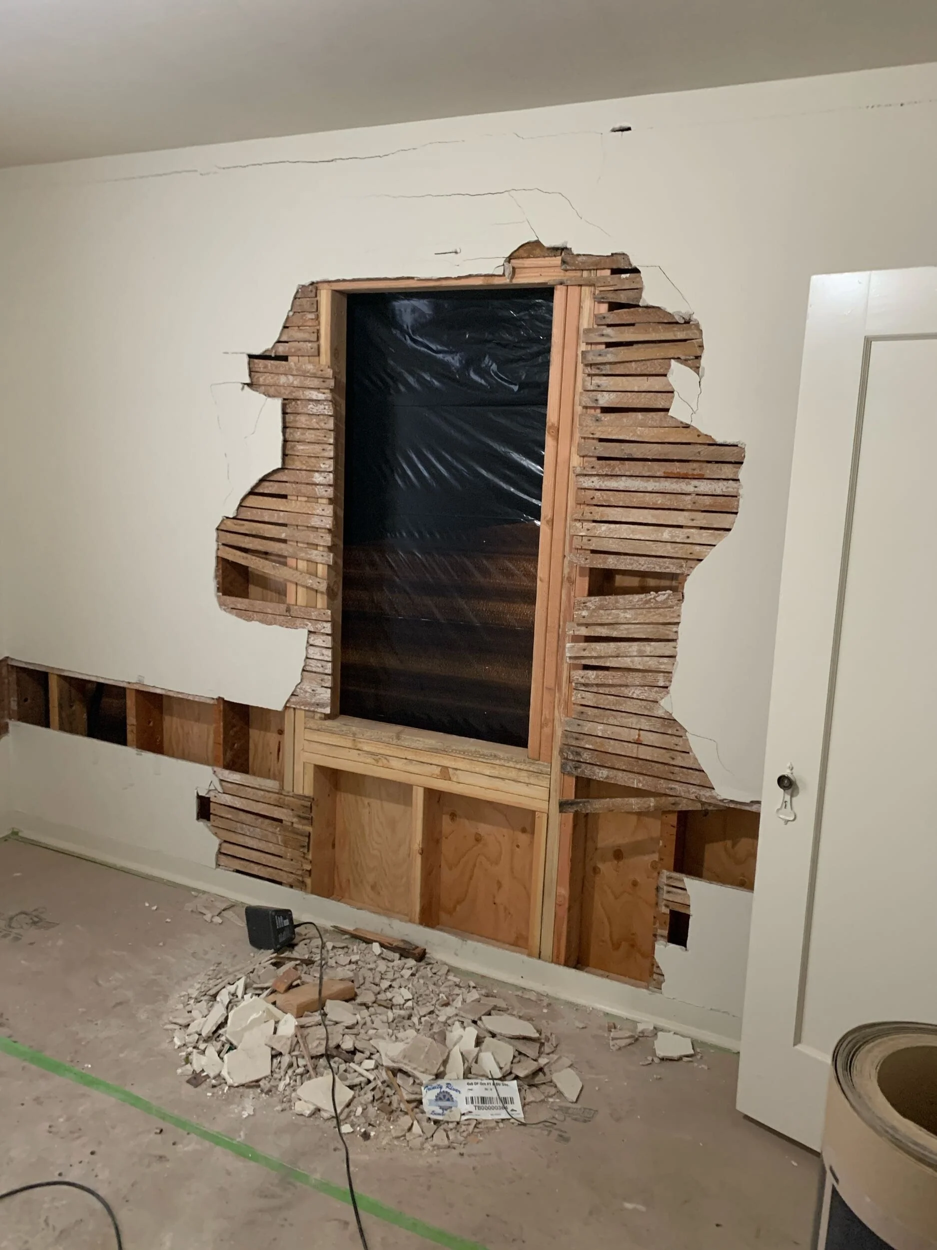 Interior wall opened during a remodel in Santa Cruz showing original lathe and plaster construction beneath modern drywall