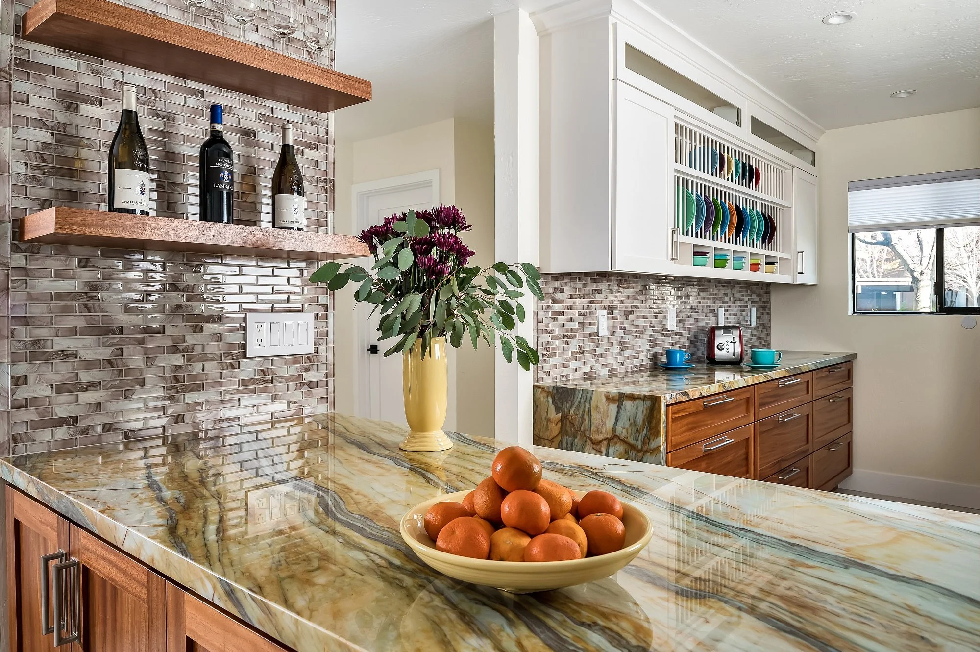 Custom kitchen remodel with quartzite waterfall countertop, mosaic tile backsplash, and walnut floating shelves by Elite Construction Santa Cruz.