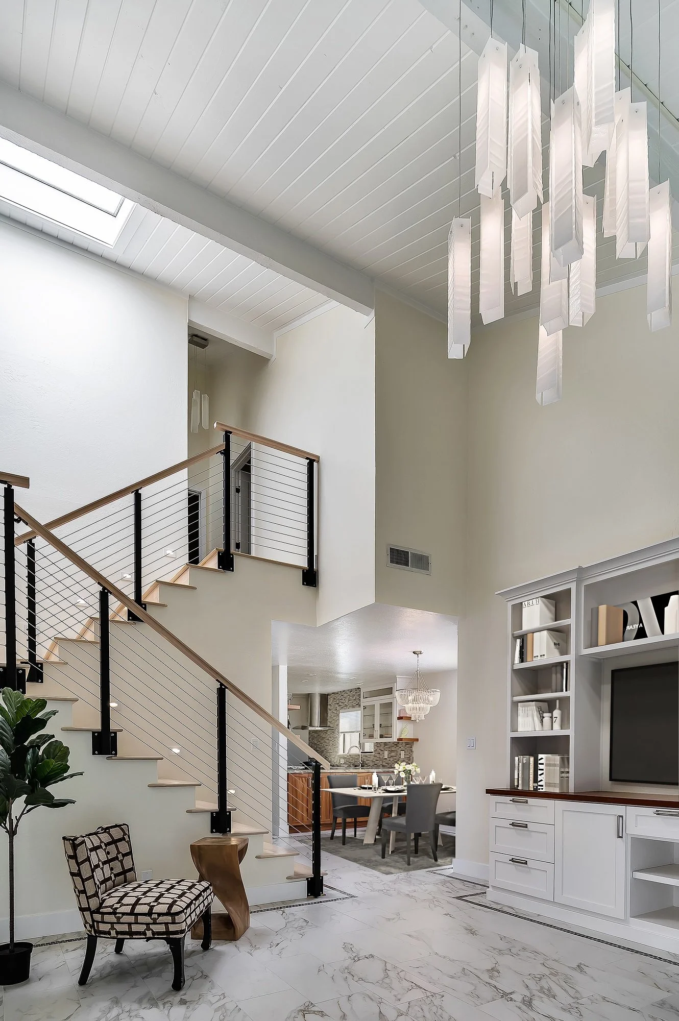 Wide interior view from a Santa Cruz condo remodel highlighting the open stair, living area, and integrated architectural details.