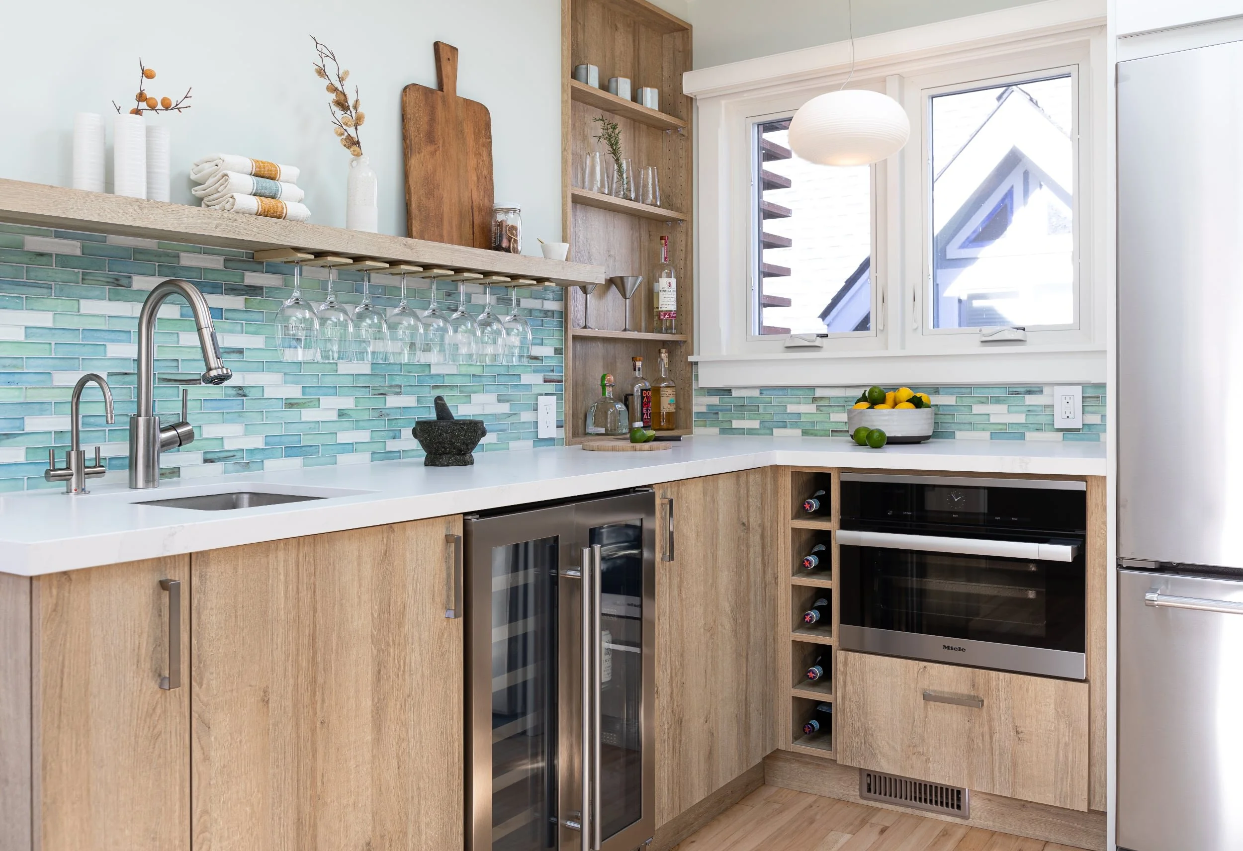 Pleasure Point kitchen remodel with light oak cabinetry, aqua tile backsplash, and modern coastal finishes