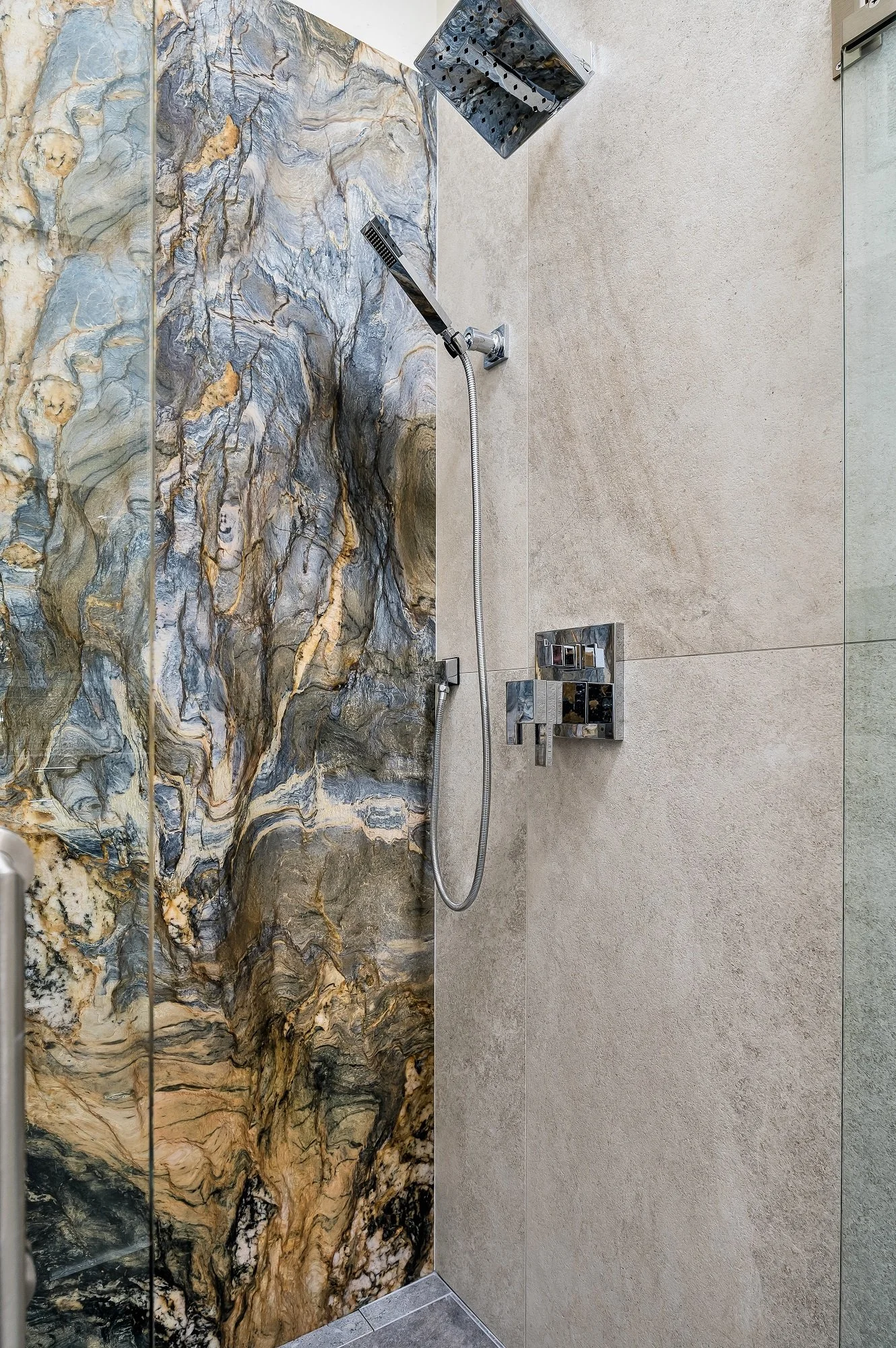 Stone slab shower feature from a Santa Cruz condo remodel, used to create contrast and visual depth within the space.
