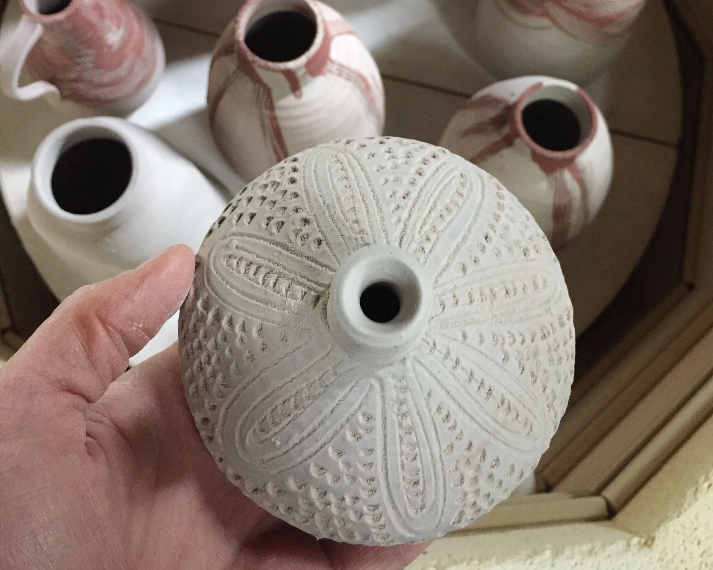 Tooled details, impressed patterns on clay.