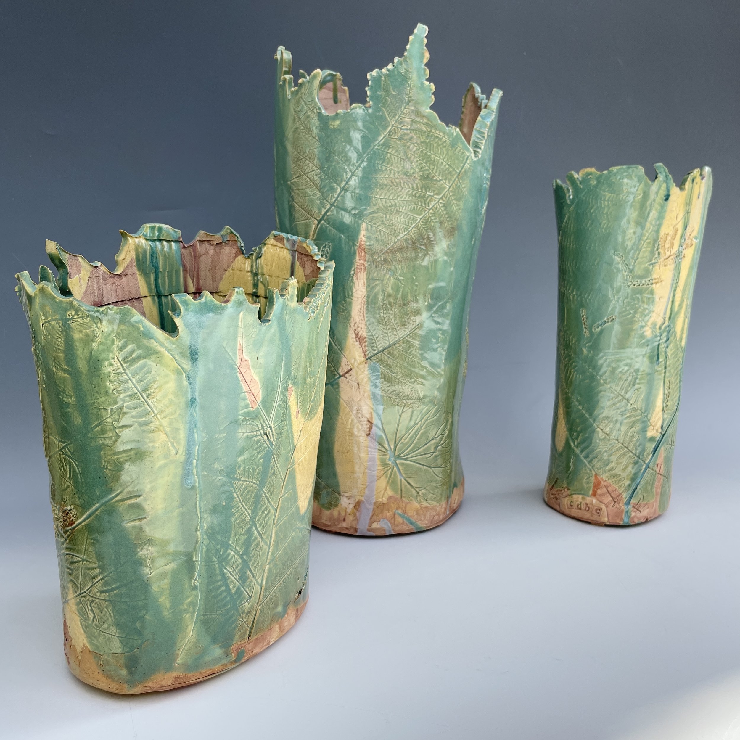 Impressed Maple Leave and Fern Fronds. Natural patterns are beautifully accented using layers of green, blue, and yellow glazes over layers of oxides on the clay's surface.
