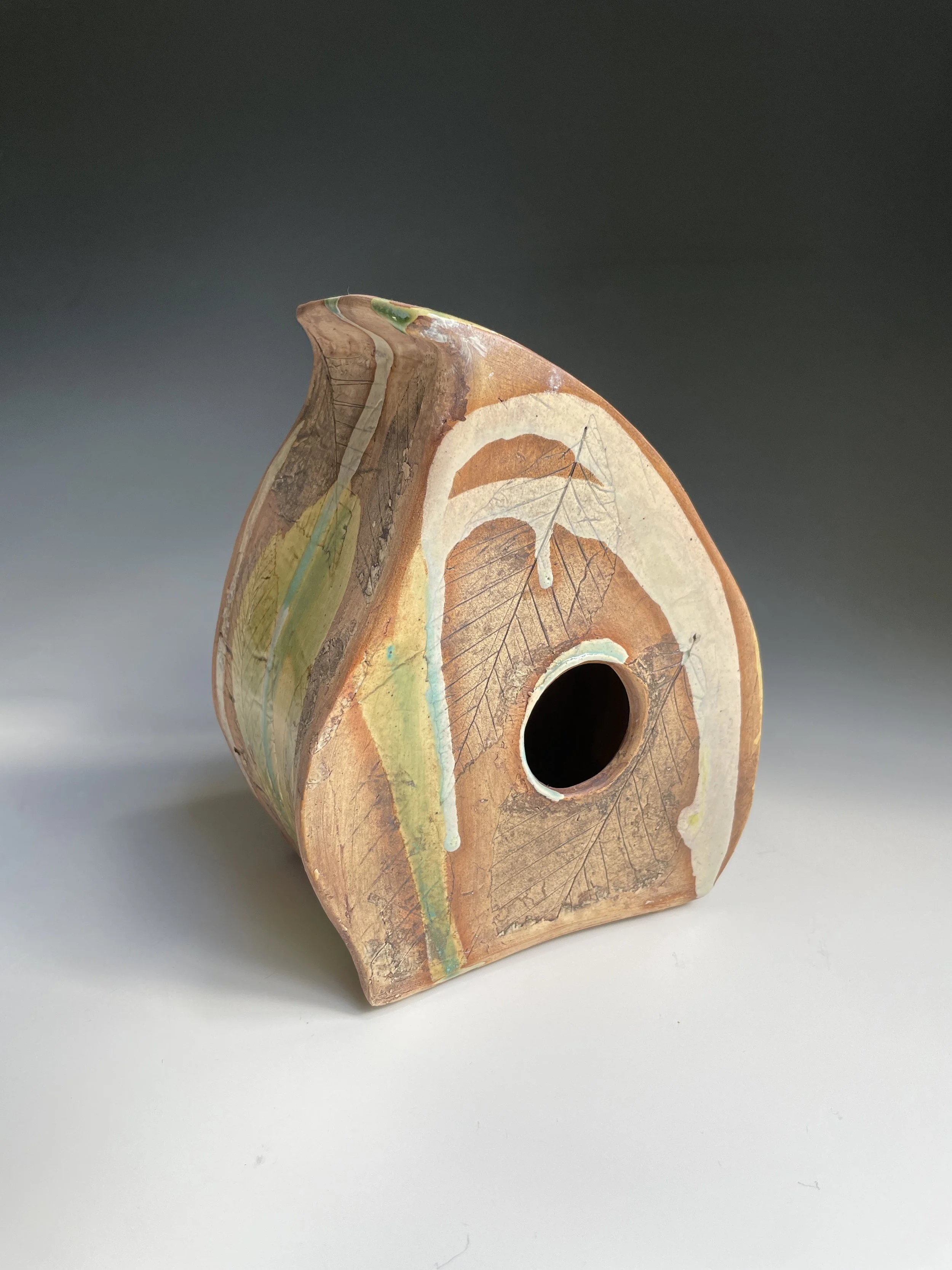 Birch leaf impressions and thoughtfully-brushed glazes on clay. Hand-built, minimalistic birdhouse.