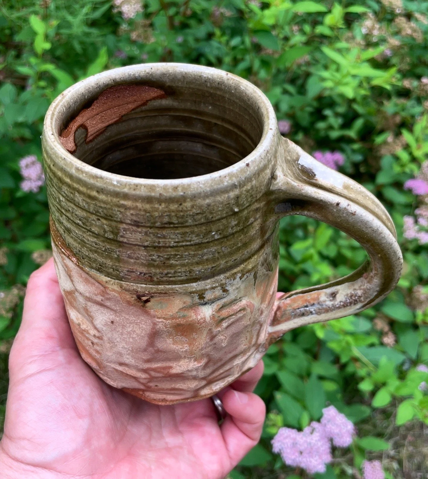Just a lovely mug, in earthy green and pink, with peek-a-boo reveal of natural clay on the inside