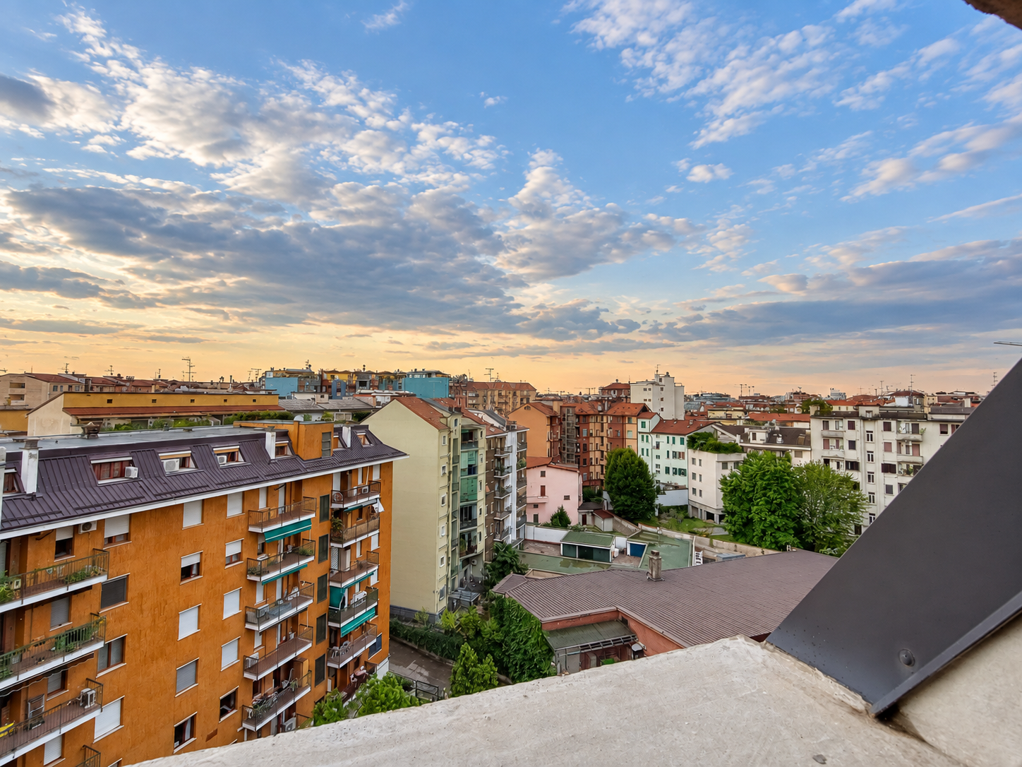 Milan rooftops and neighbourhood streets at sunset