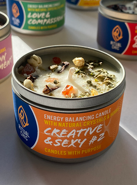 soy candle with crystals and herbs for sacral chakra