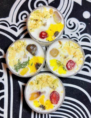 tealight candles with flower petals and crystals