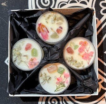 set of four tealight candles with herbs and crystals