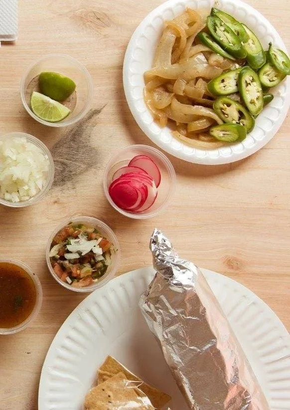 Giant burrito with side of jalapeños and grilled onions from La Piñata taco truck in Vallejo