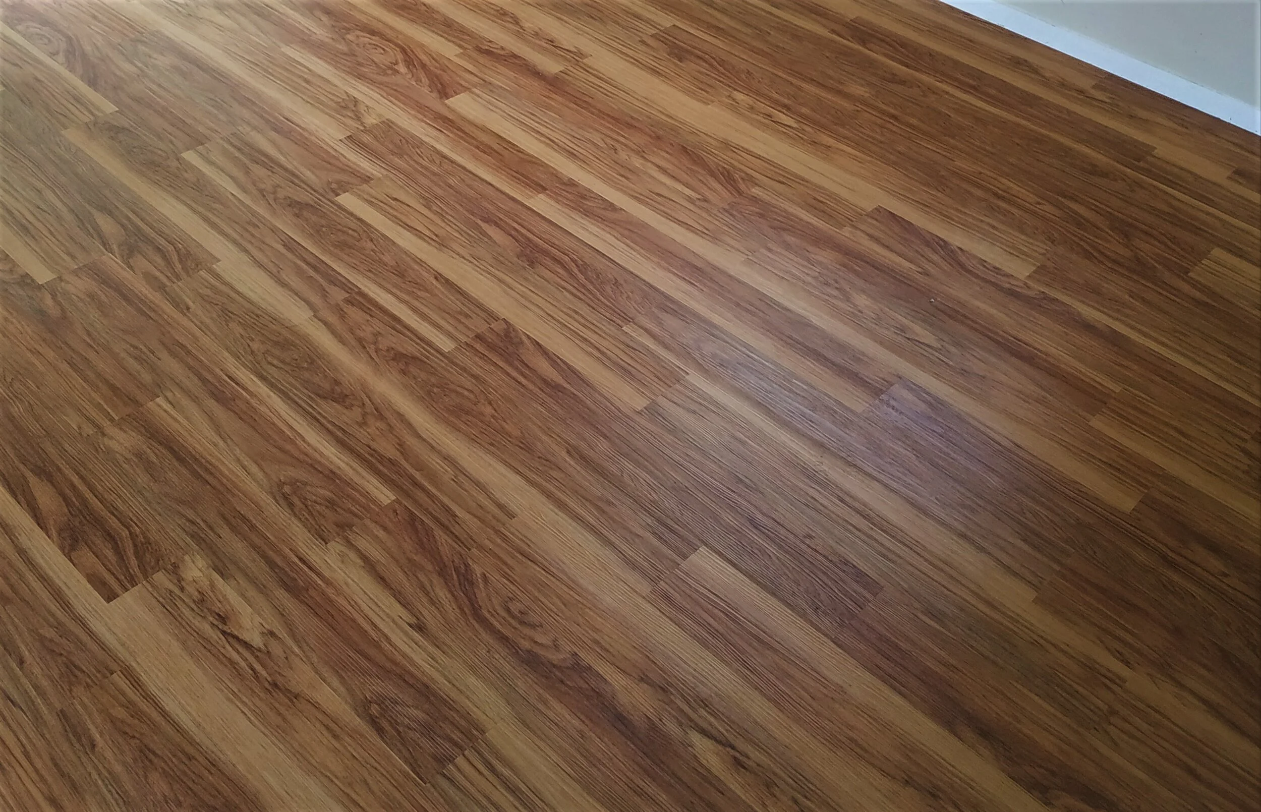 Wooden floor with a light brown finish and visible wood grain patterns.