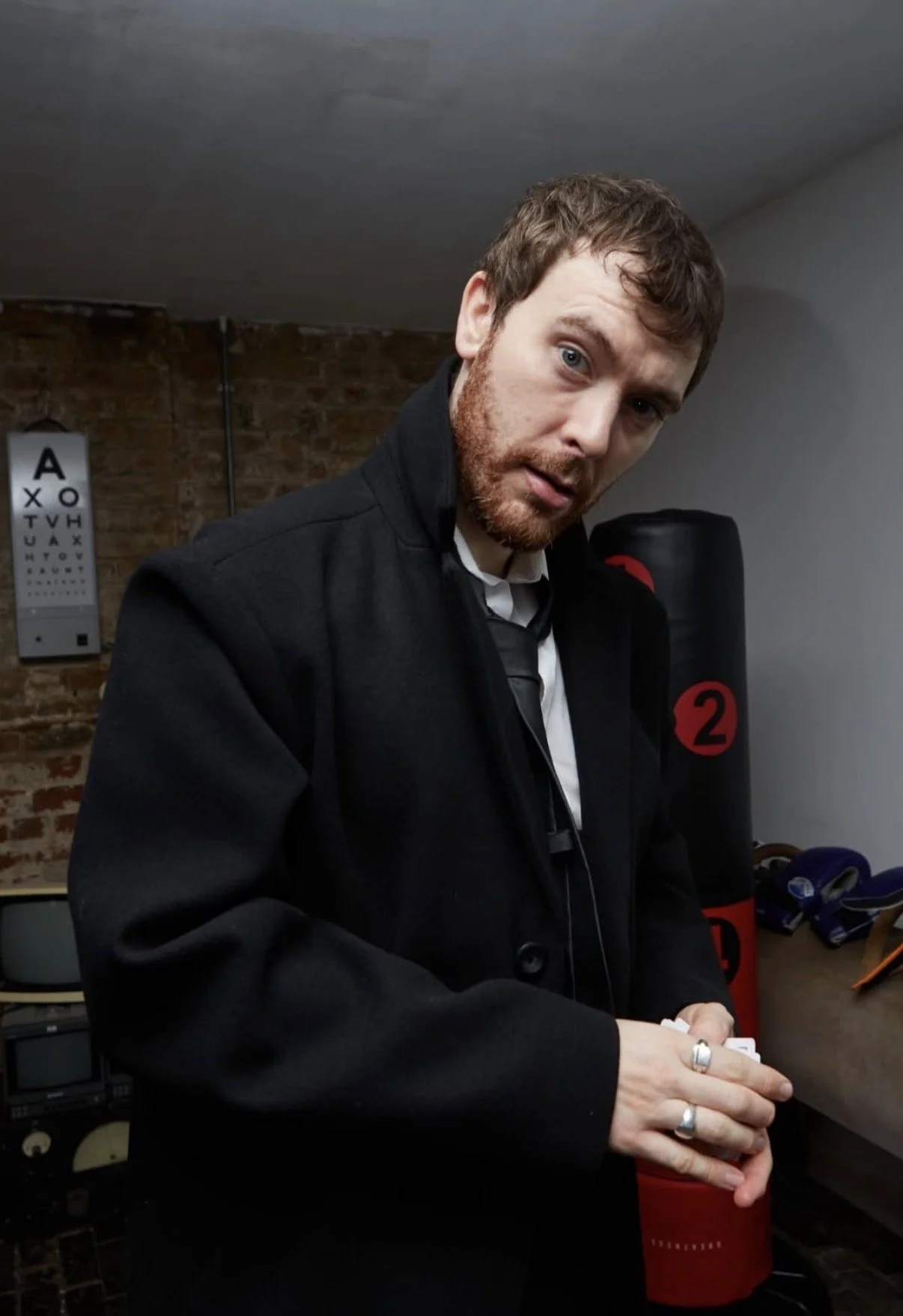 Actor leading an interactive murder mystery experience, custom-designed for a private event with guests fully immersed in the story.