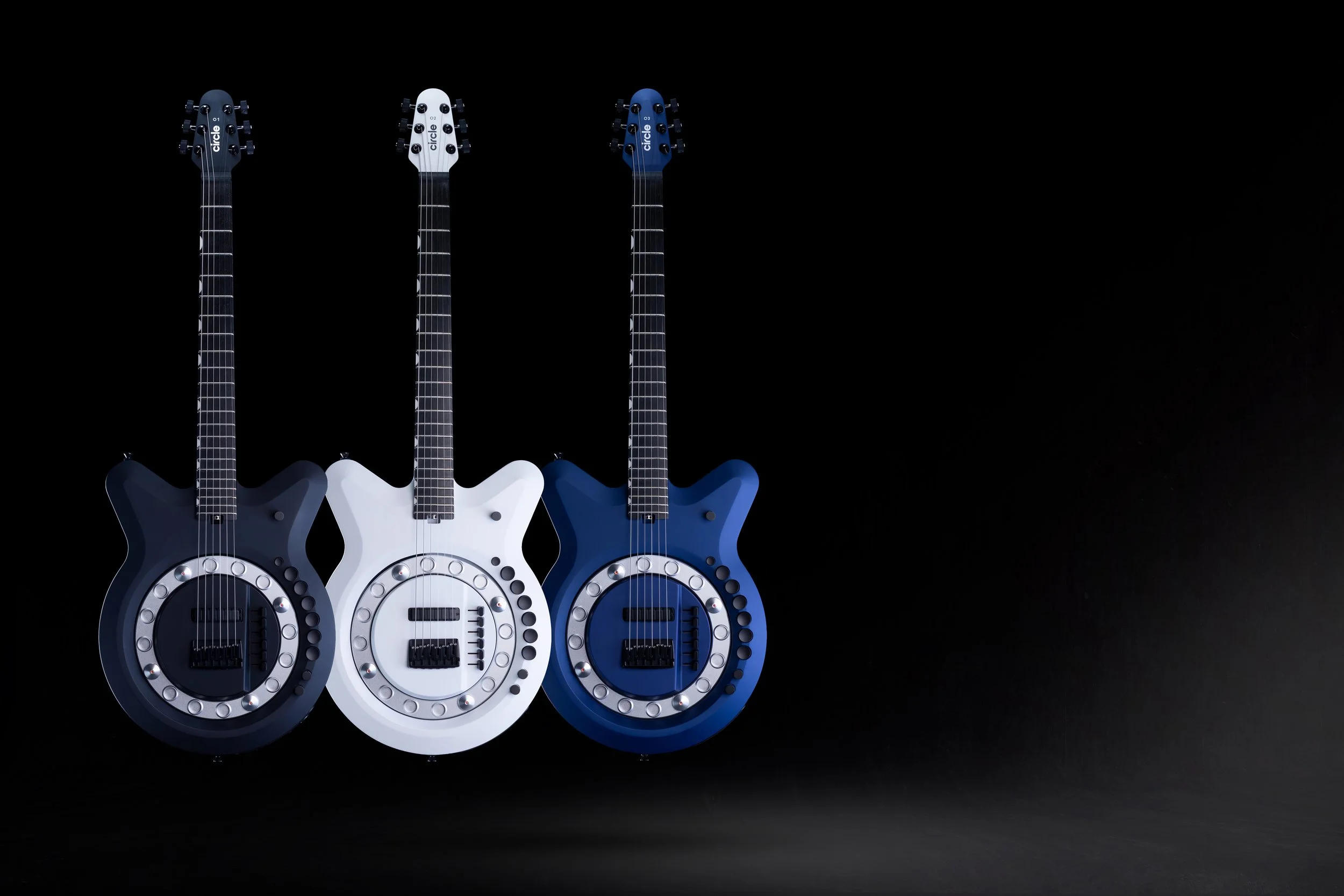 Three Circle Guitars in charcoal, white and blue